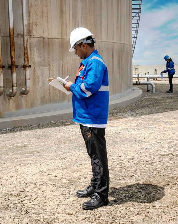 IRC inspector recording findings at a storage tank